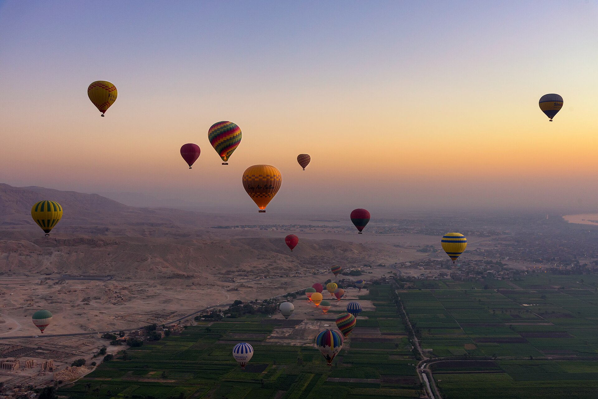 Hot air balloons at sunrise over the Valley of the Kings